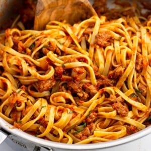 Spicy sausage fettuccine in a pan.