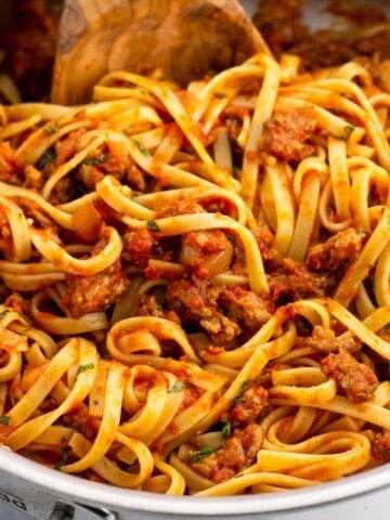 Spicy sausage fettuccine in a pan.