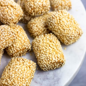 Sesame cookies on a marble serving plate.