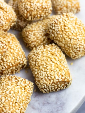 Sesame cookies on a marble serving plate.