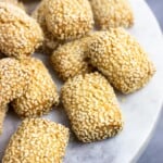 A marble serving plate of sesame cookies.