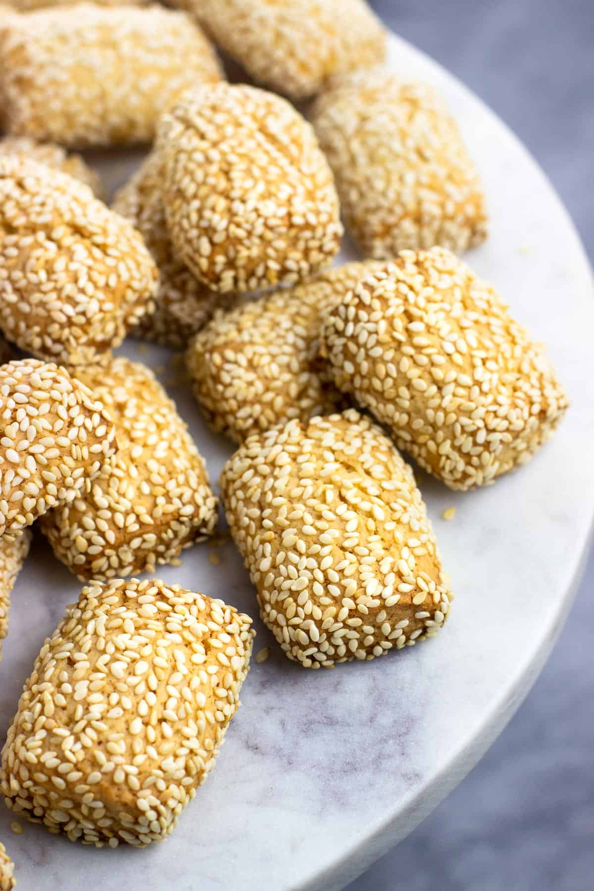 A marble serving plate of sesame cookies.