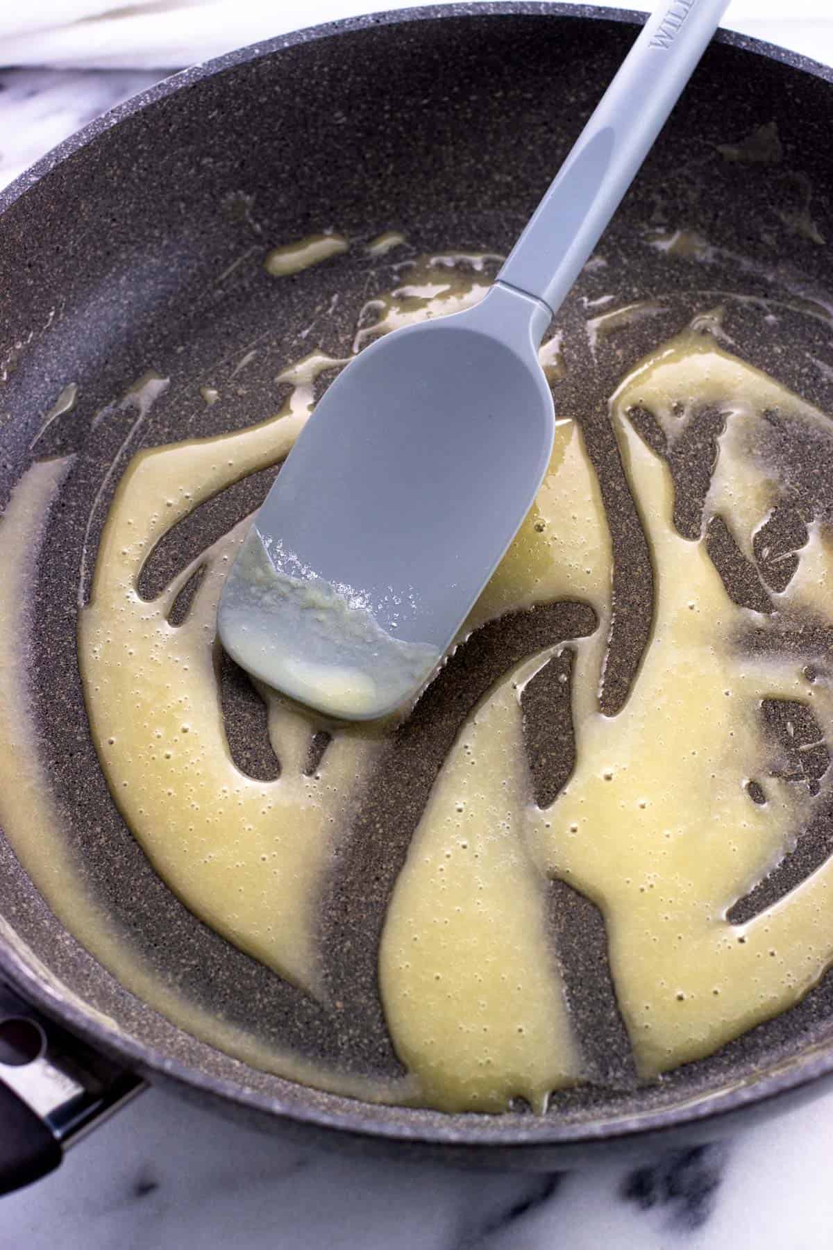 Thickened butter and flour in a pan with a spatula.