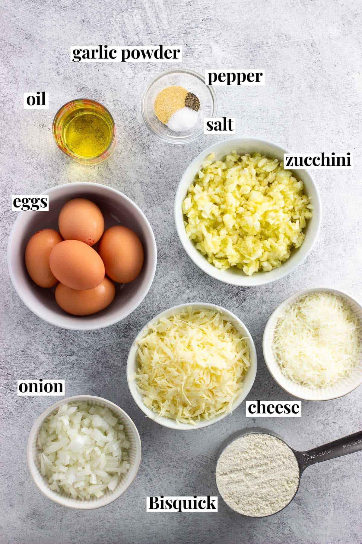 Text labeled zucchini pie ingredients in separate bowls.