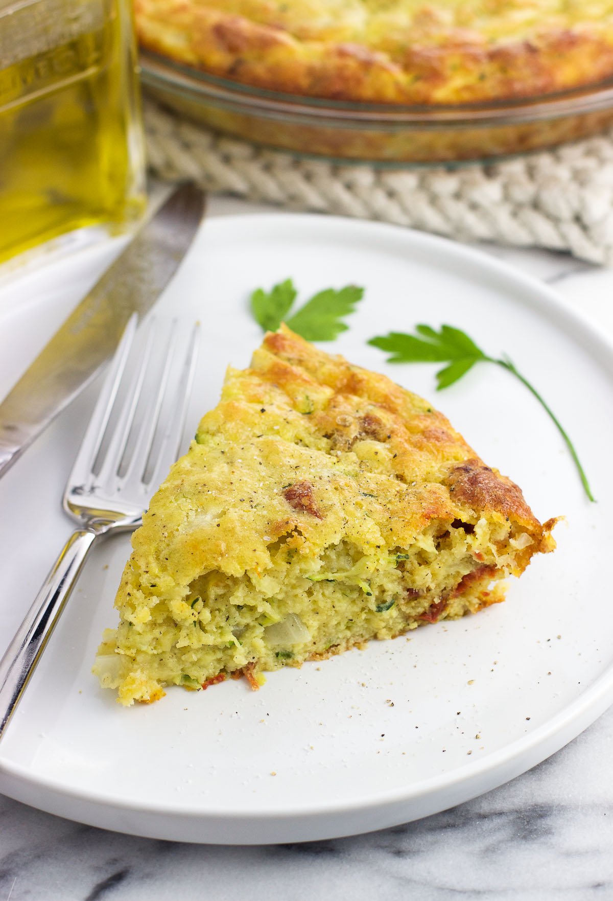 A slice of zucchini pie on a plate.