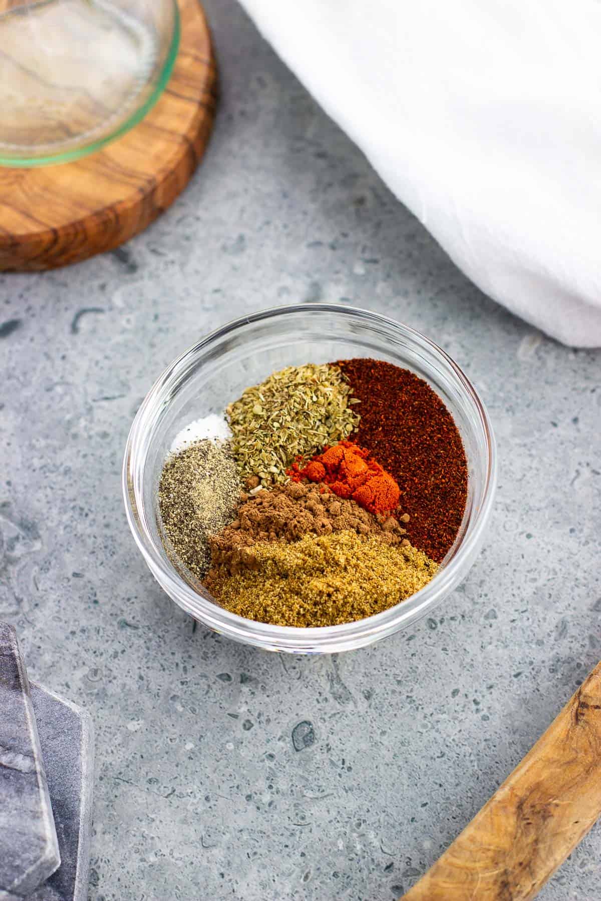 Various chili seasoning spices in a small glass bowl.