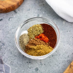 Various chili seasoning spices in a small glass bowl.