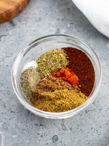 Various chili seasoning spices in a small glass bowl.