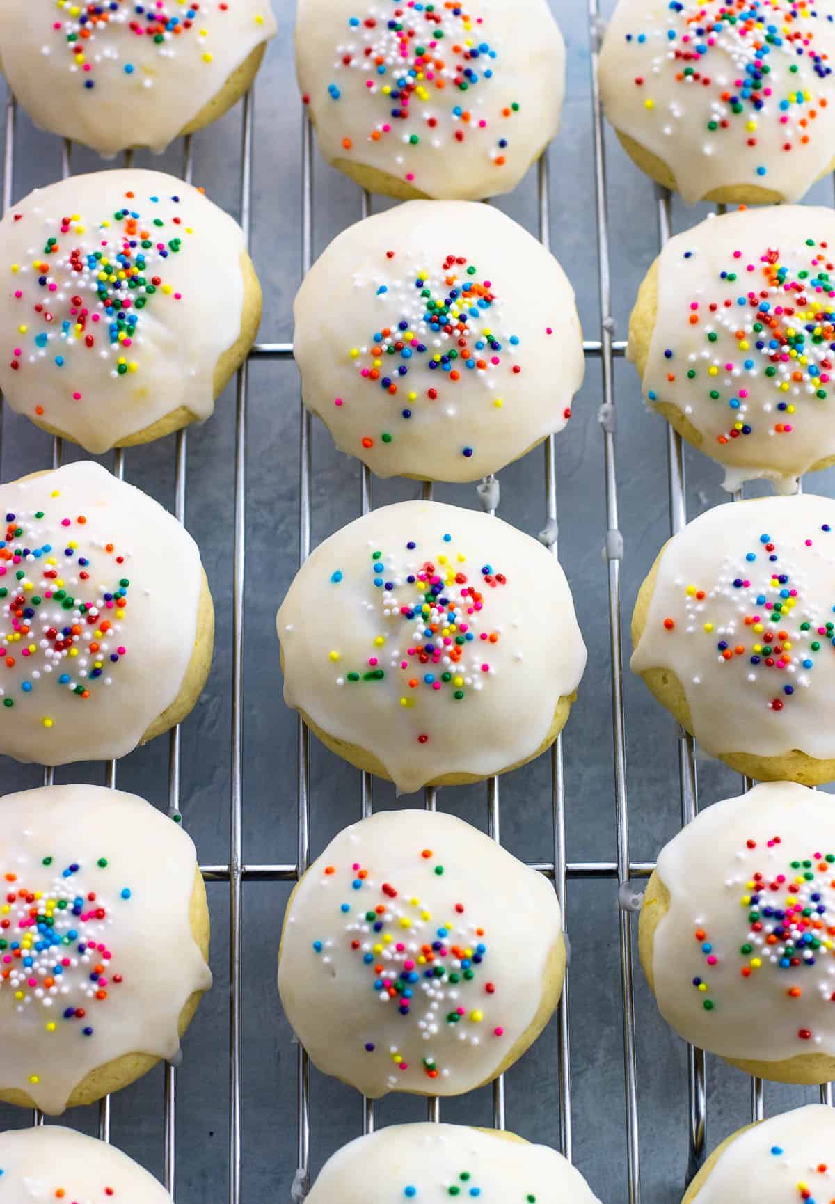 A batch of anginetti cookies drying on a wire rack.