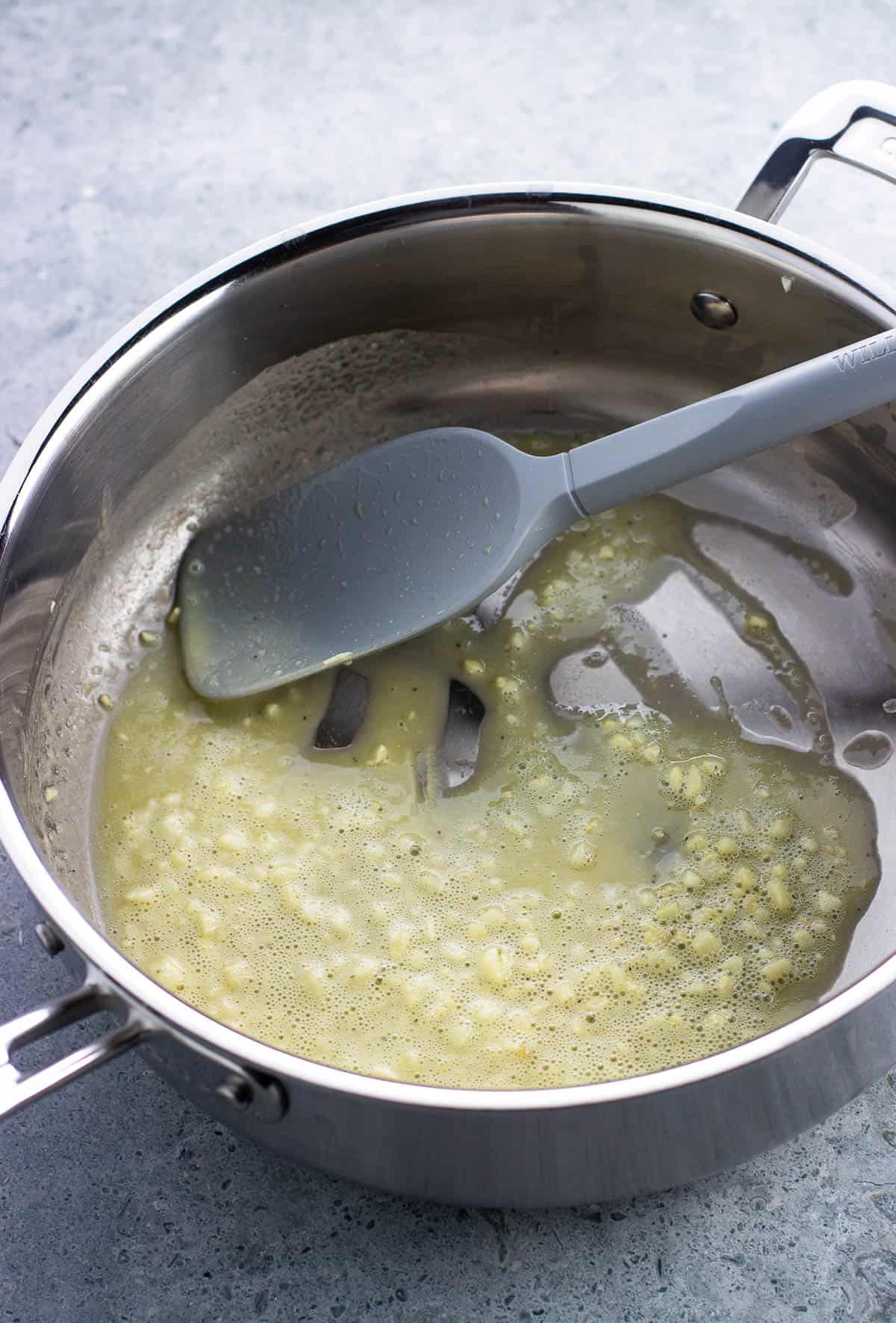 Flour added to the oil, butter, and garlic and thickened.