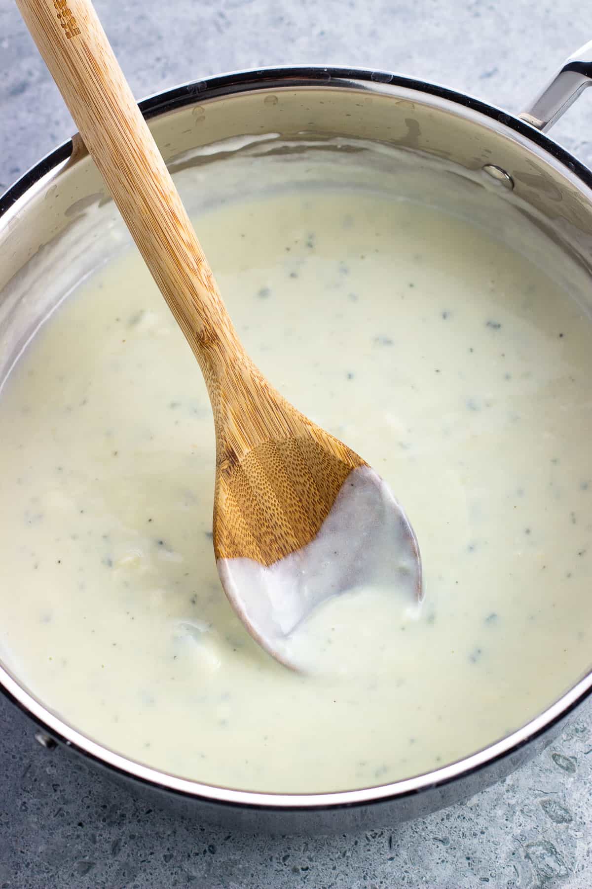All Gorgonzola sauce ingredients added to the pan and thickened to coat a wooden spoon.