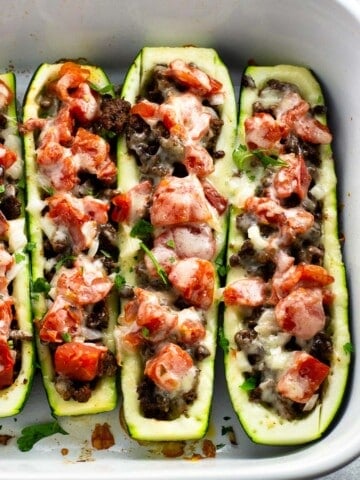 Taco zucchini boats in a baking dish ready to serve.