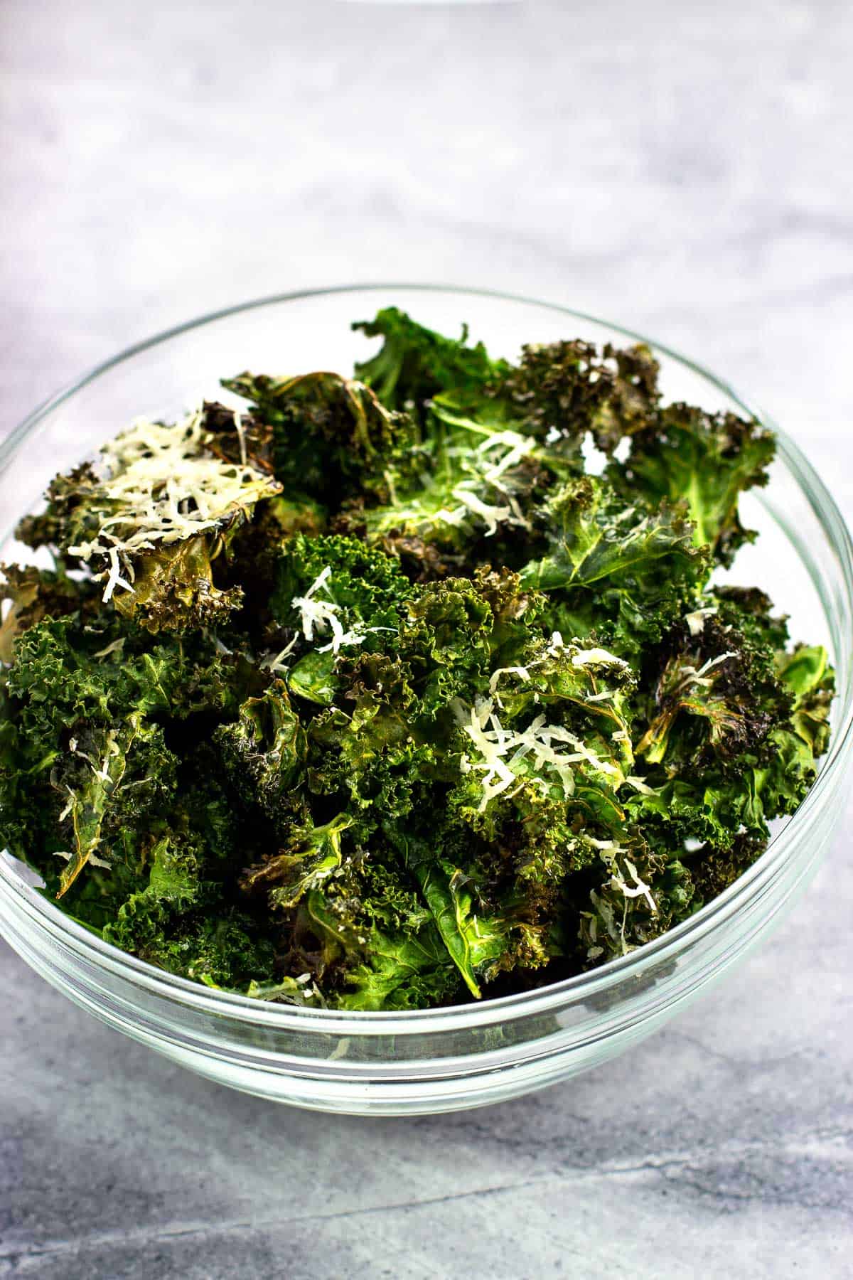 A glass bowl of air fryer kale chips.