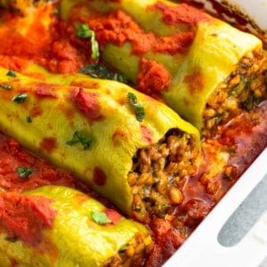 Stuffed cubanelle peppers in large dish after being baked.