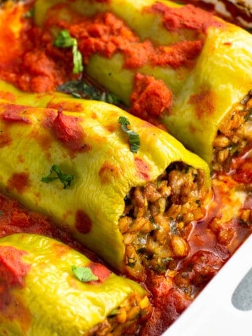 Stuffed cubanelle peppers in large dish after being baked.