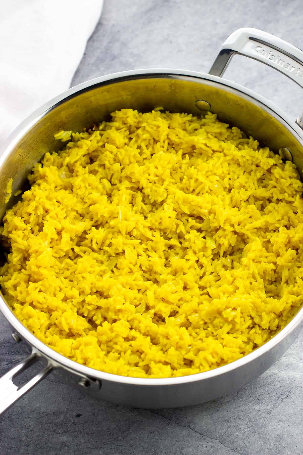 A pan of cooked turmeric coconut rice.