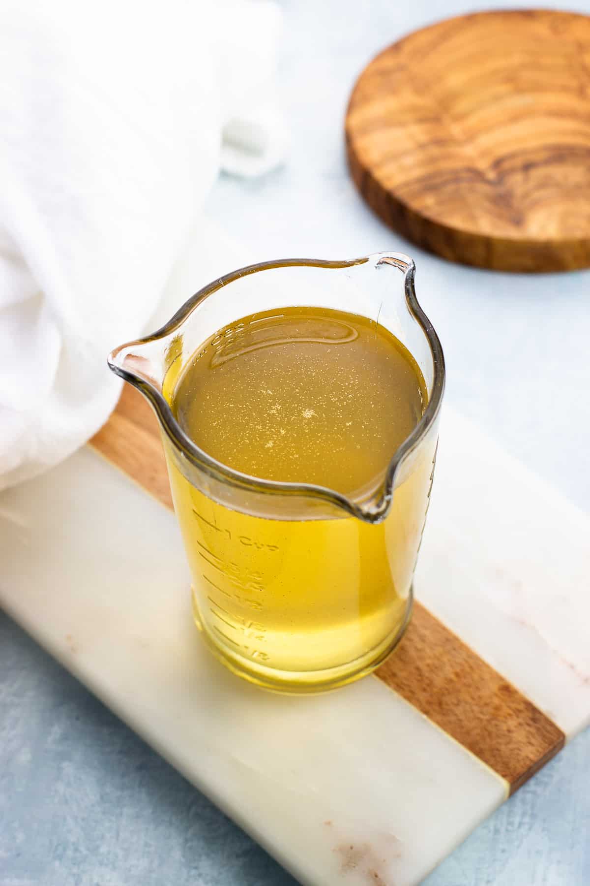 Strained anise cinnamon syrup in a glass measuring cup.