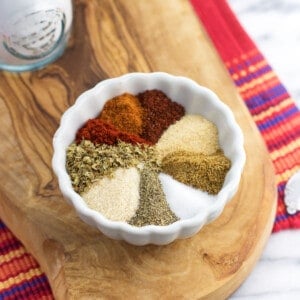 All of the taco seasoning ingredients poured into a bowl before mixing together.