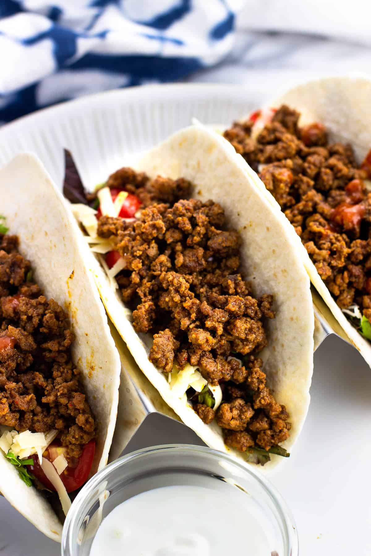 Three beef tacos on a plate.
