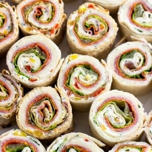 A large plate of Italian pinwheel sandwiches.