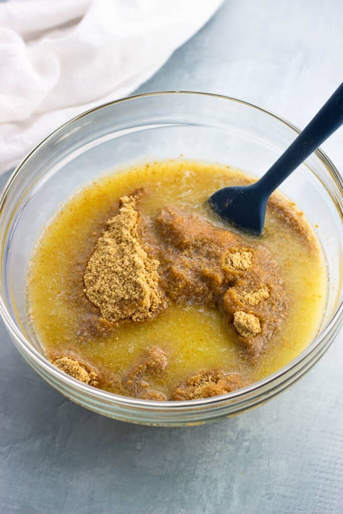 Crust ingredients being combined in a glass mixing bowl.