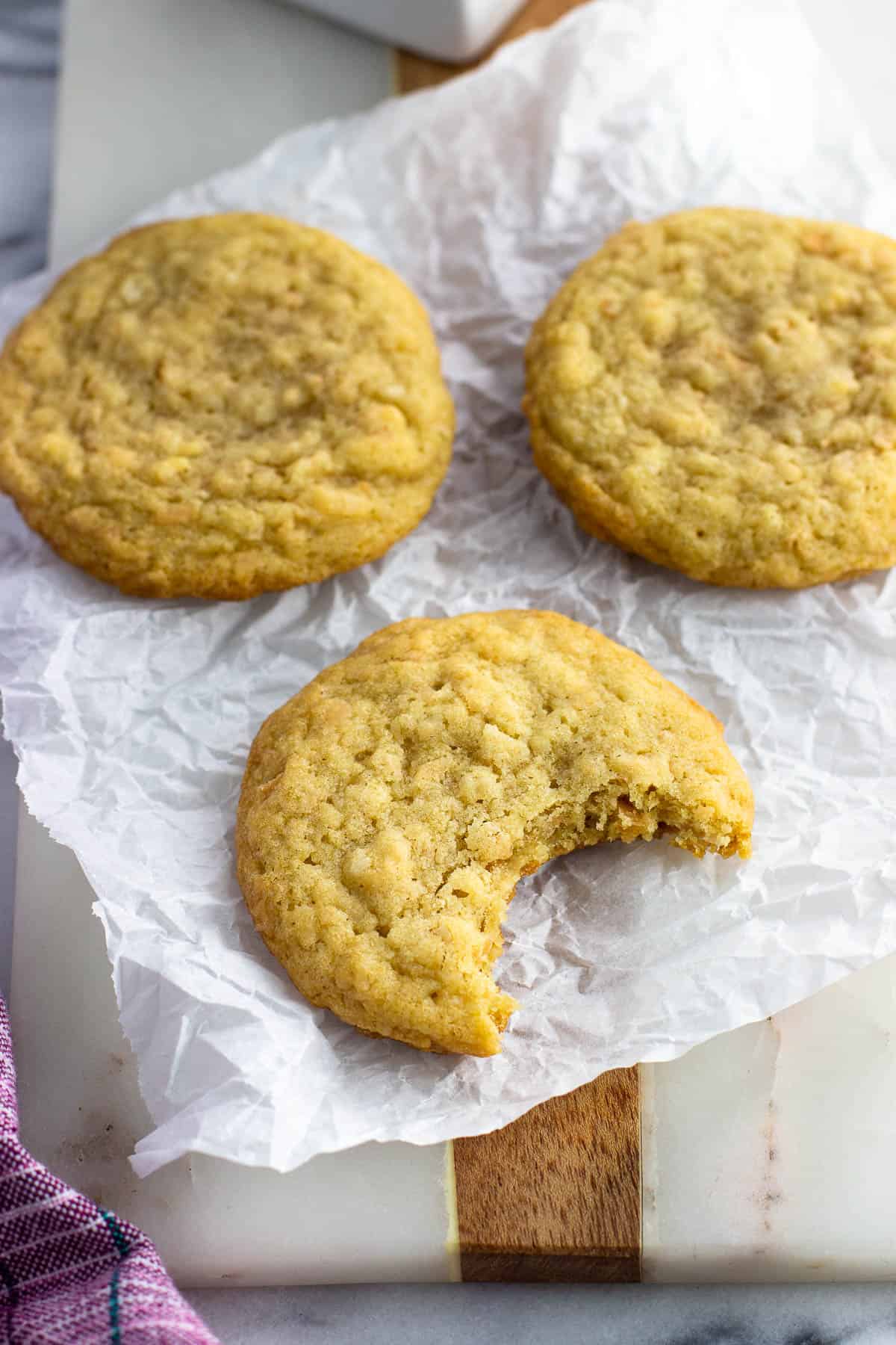 A big bite taken out of a cookie with two others.