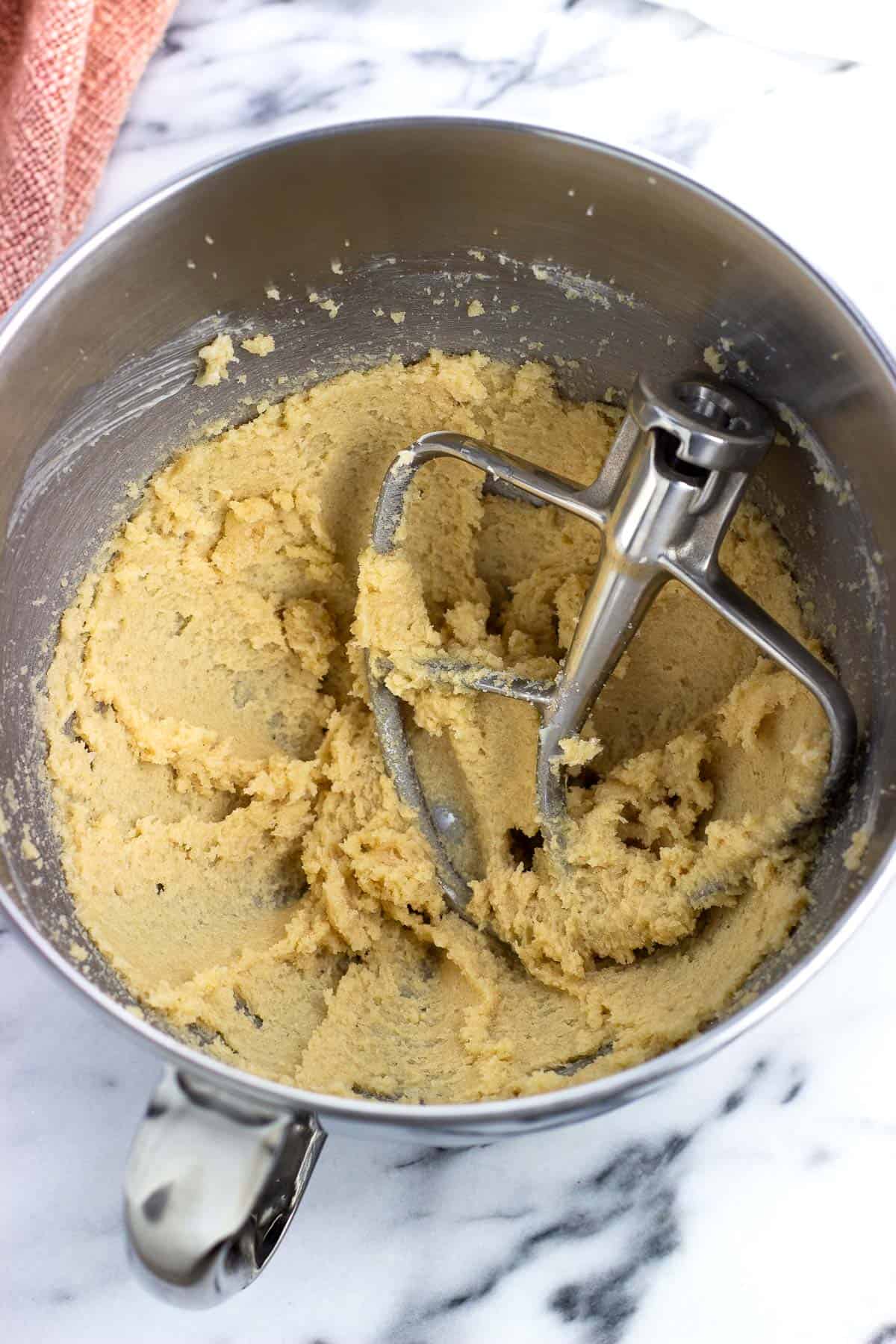 Butter and granulated and brown sugars creamed in a mixing bowl.