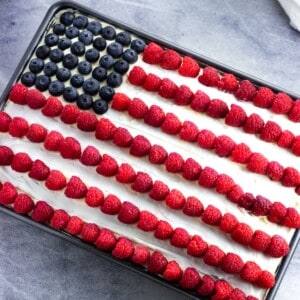 An American Flag depicted in berries on top of an ice cream sandwich cake.