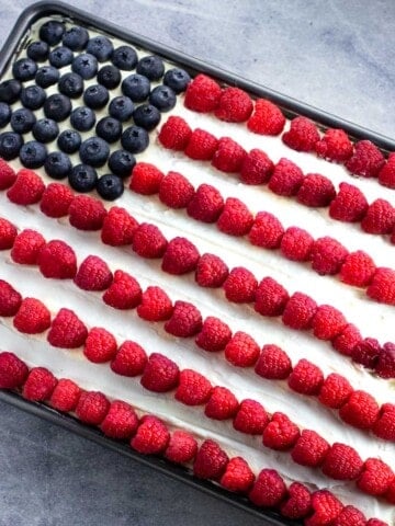 An American Flag depicted in berries on top of an ice cream sandwich cake.