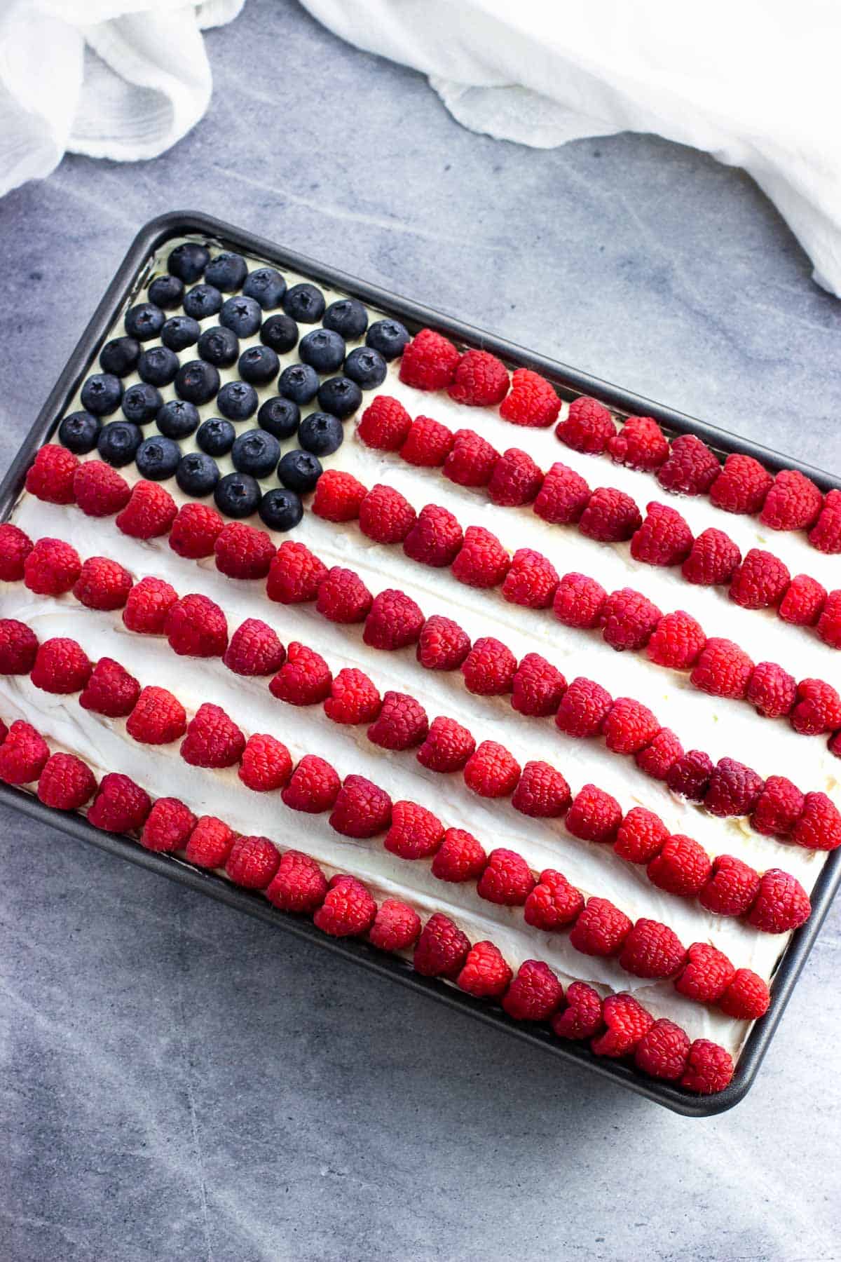 An American Flag depicted in berries on top of an ice cream sandwich cake.