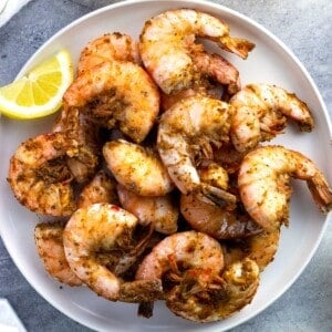 A plate of large steamed shrimp coated in Old Bay.