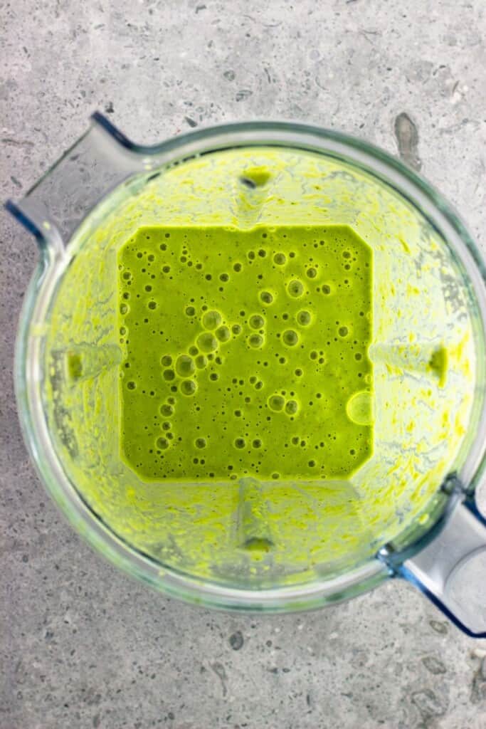 The processed matcha smoothie in the blender.