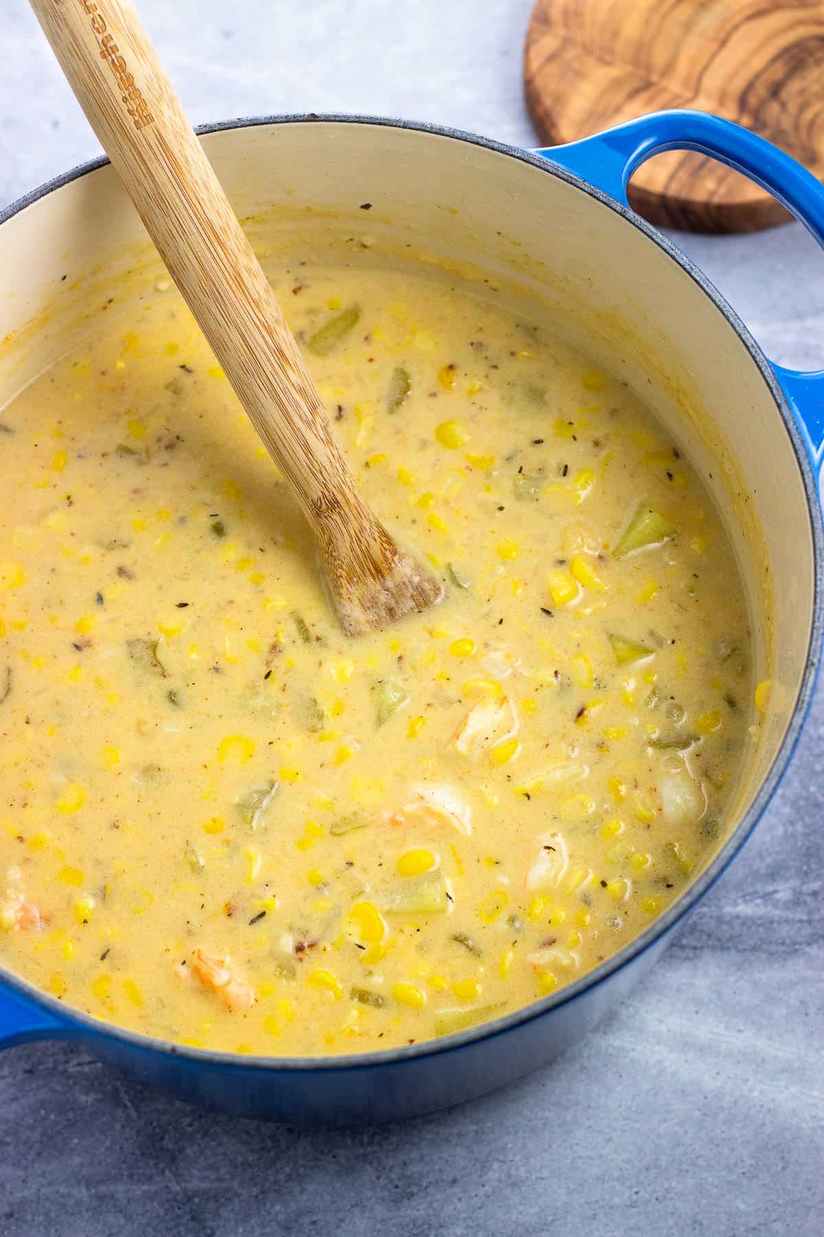 A Dutch oven of shrimp corn chowder after the shrimp has cooked.