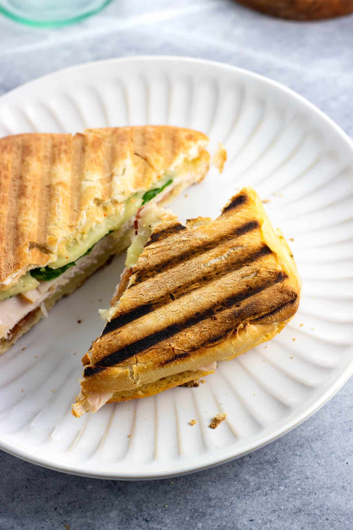 Deep grill lines formed on the bottom of a panini half.