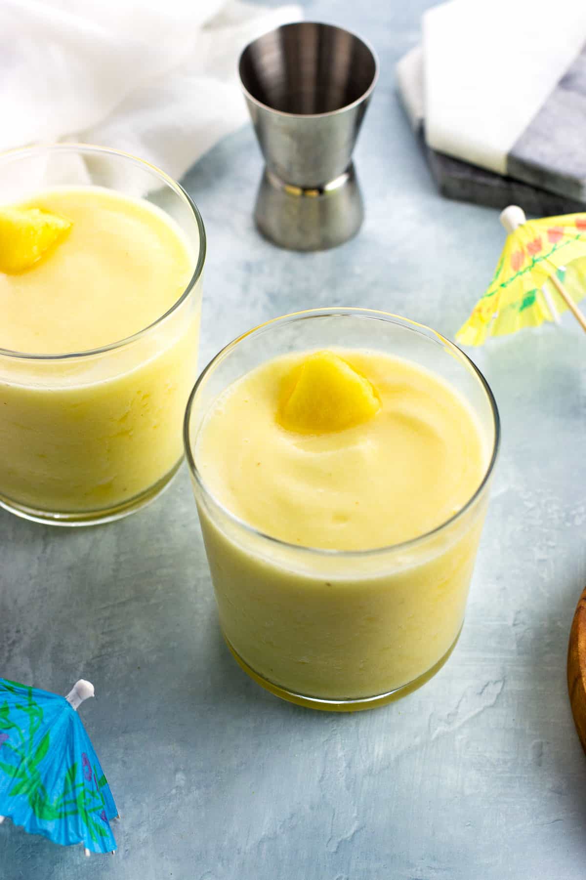 Two healthier piña coladas in short glasses.