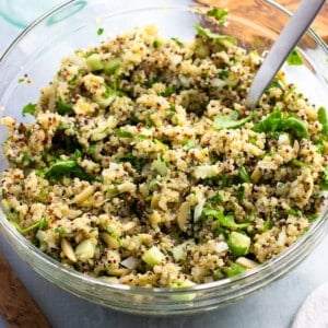 Lemon quinoa salad with Parmesan and herbs in a glass bowl.