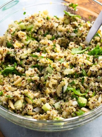 Lemon quinoa salad with Parmesan and herbs in a glass bowl.