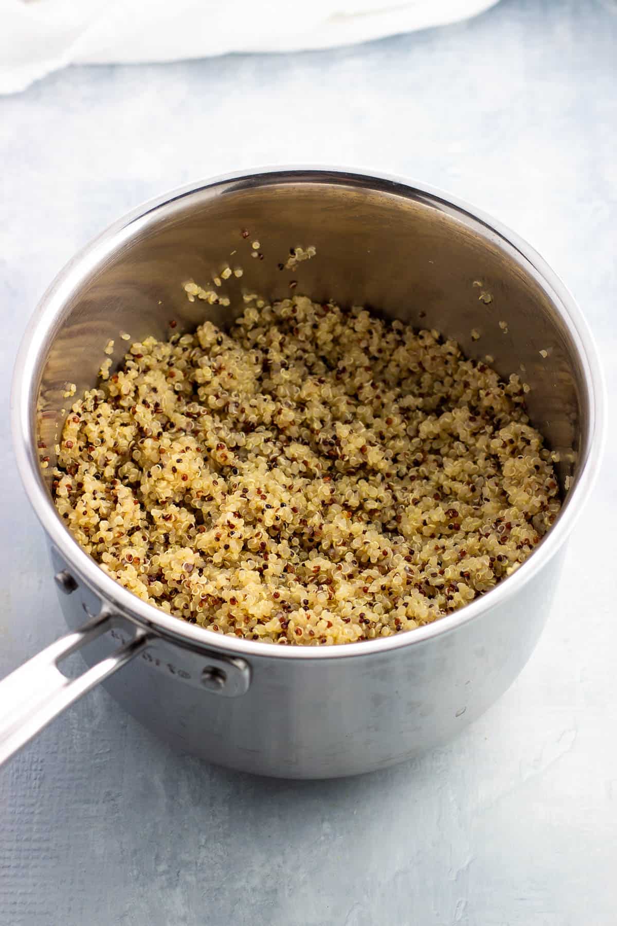 Cooked fluffy quinoa in a medium saucepan.