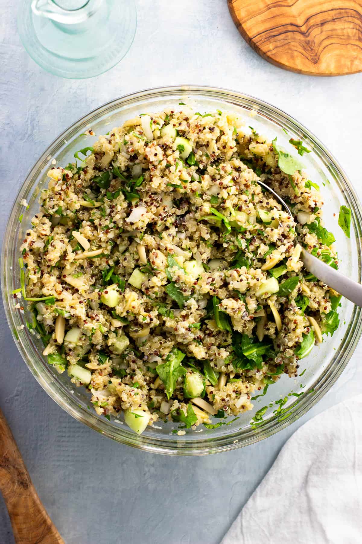 Lemon quinoa salad stirred together in a bowl.