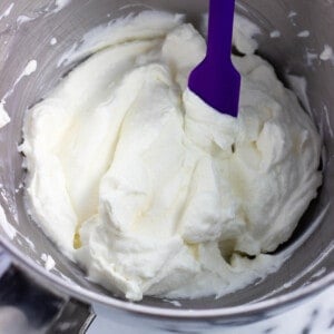 Fluffy gelatin-stabilized whipped cream in a bowl with a spatula.