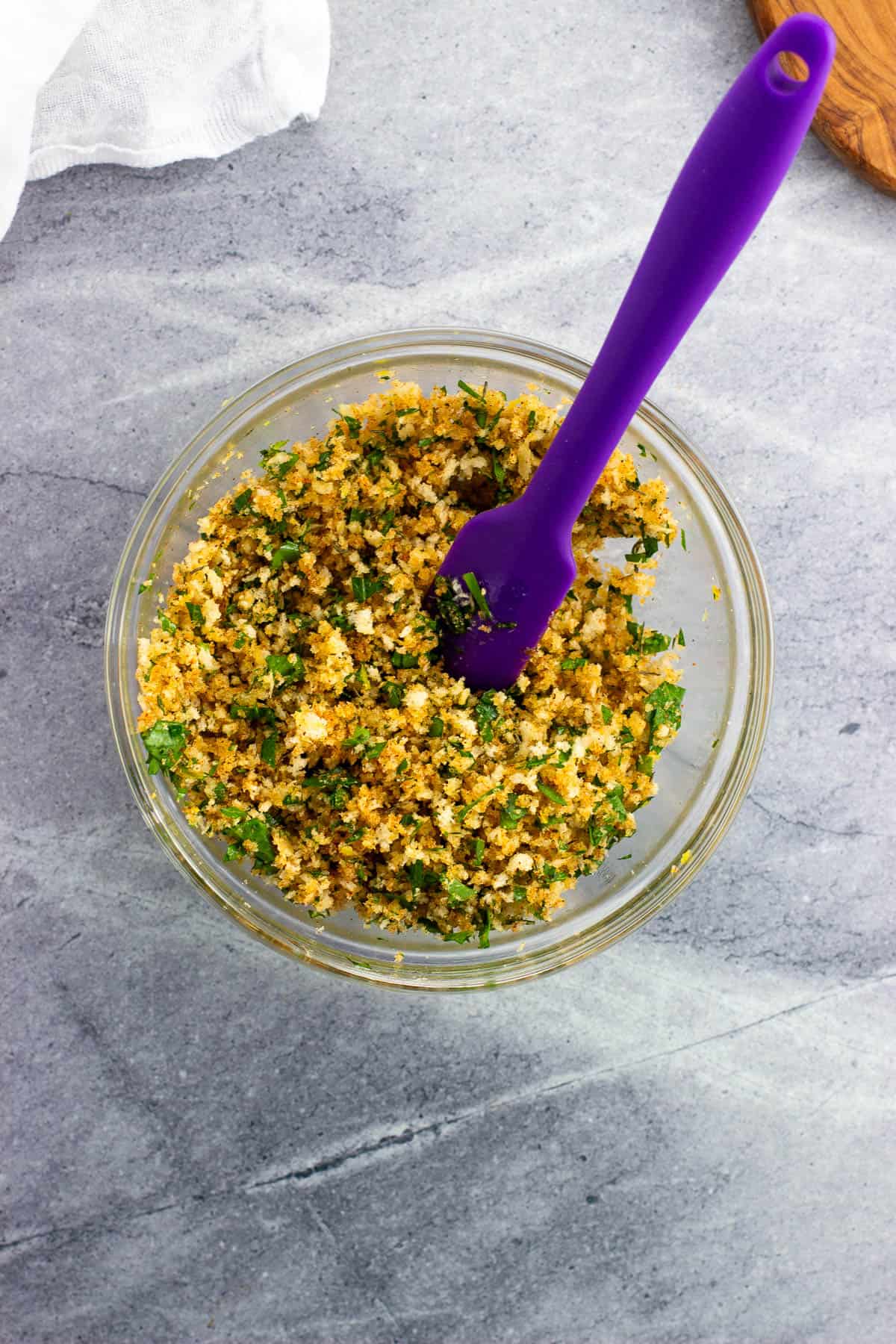 The panko breadcrumb topping mixed together in a bowl with a spatula.