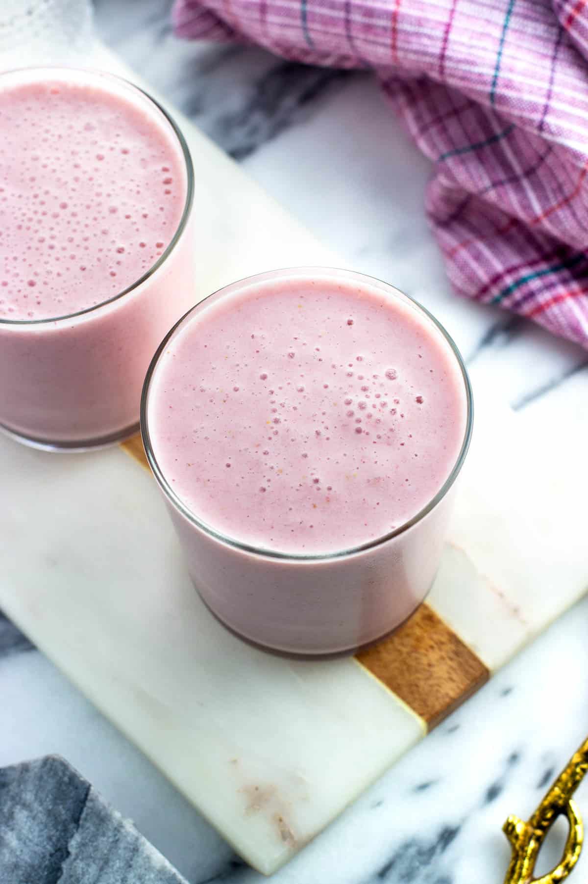 Two cottage cheese smoothies in short glasses.