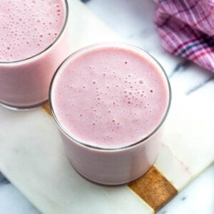 Two cottage cheese smoothies in short glasses.