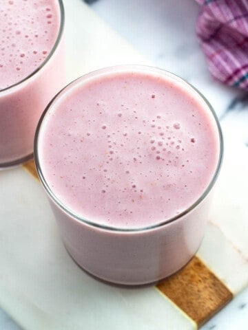 Two cottage cheese smoothies in short glasses.