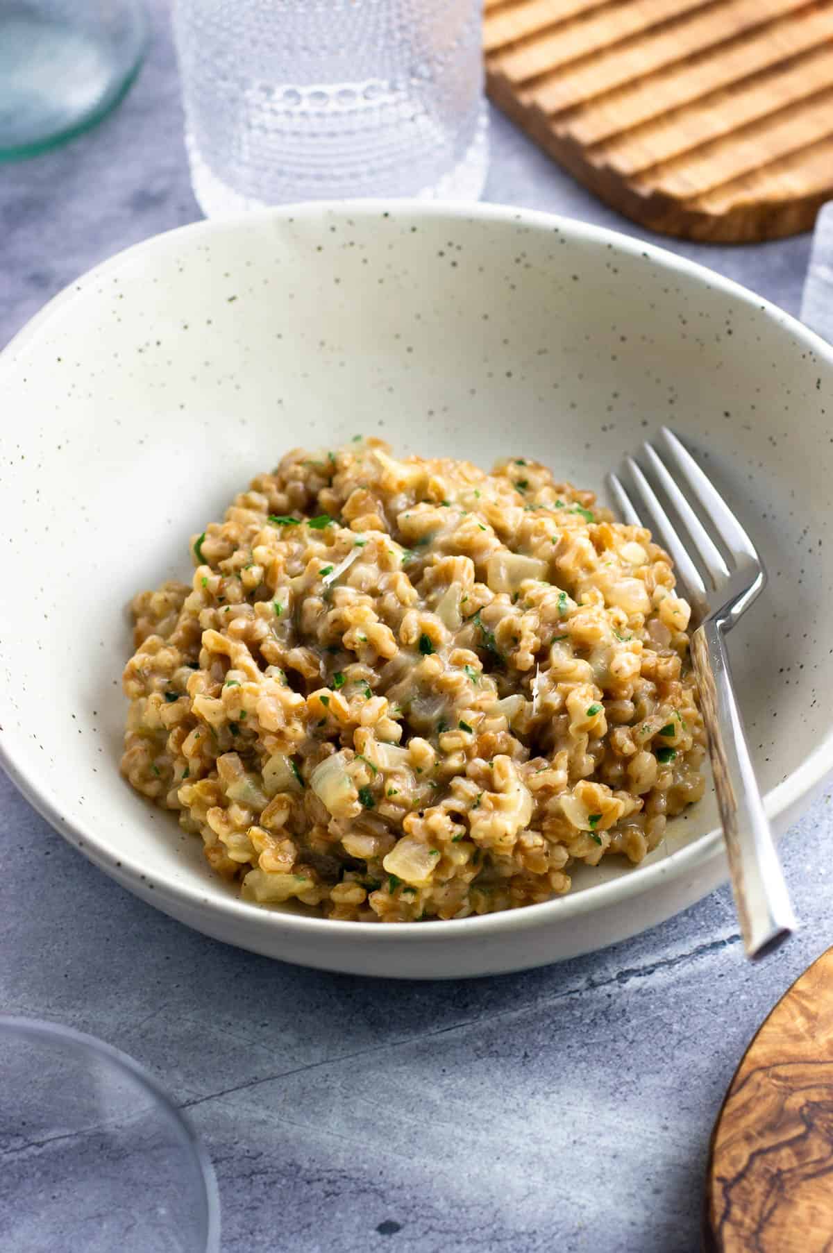 A serving of creamy farro risotto in a shallow bowl.