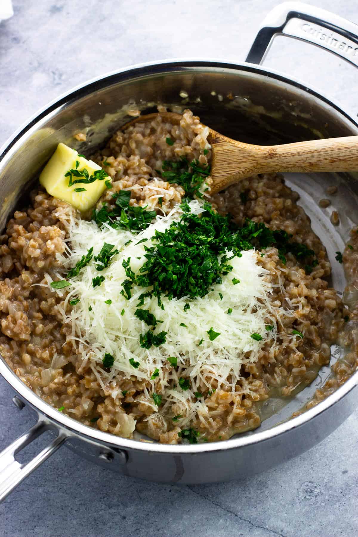 Shredded Parmesan, parsley, butter, and pepper added to the cooked farrotto.