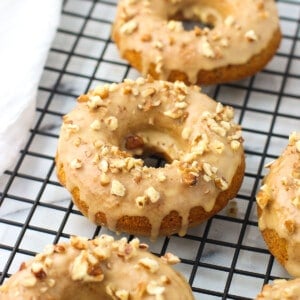 Baked pumpkin donuts on a wire rack.