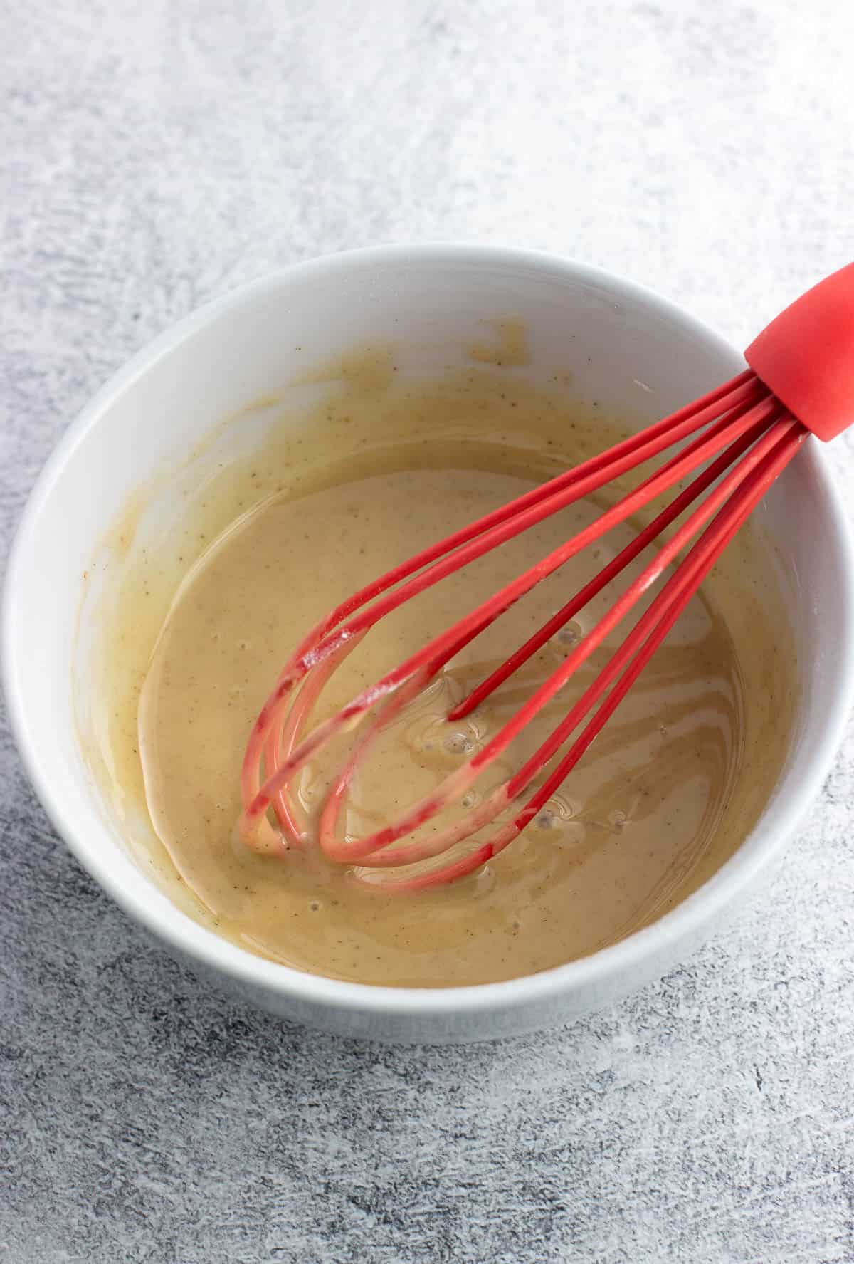 Whisked glaze in a bowl.