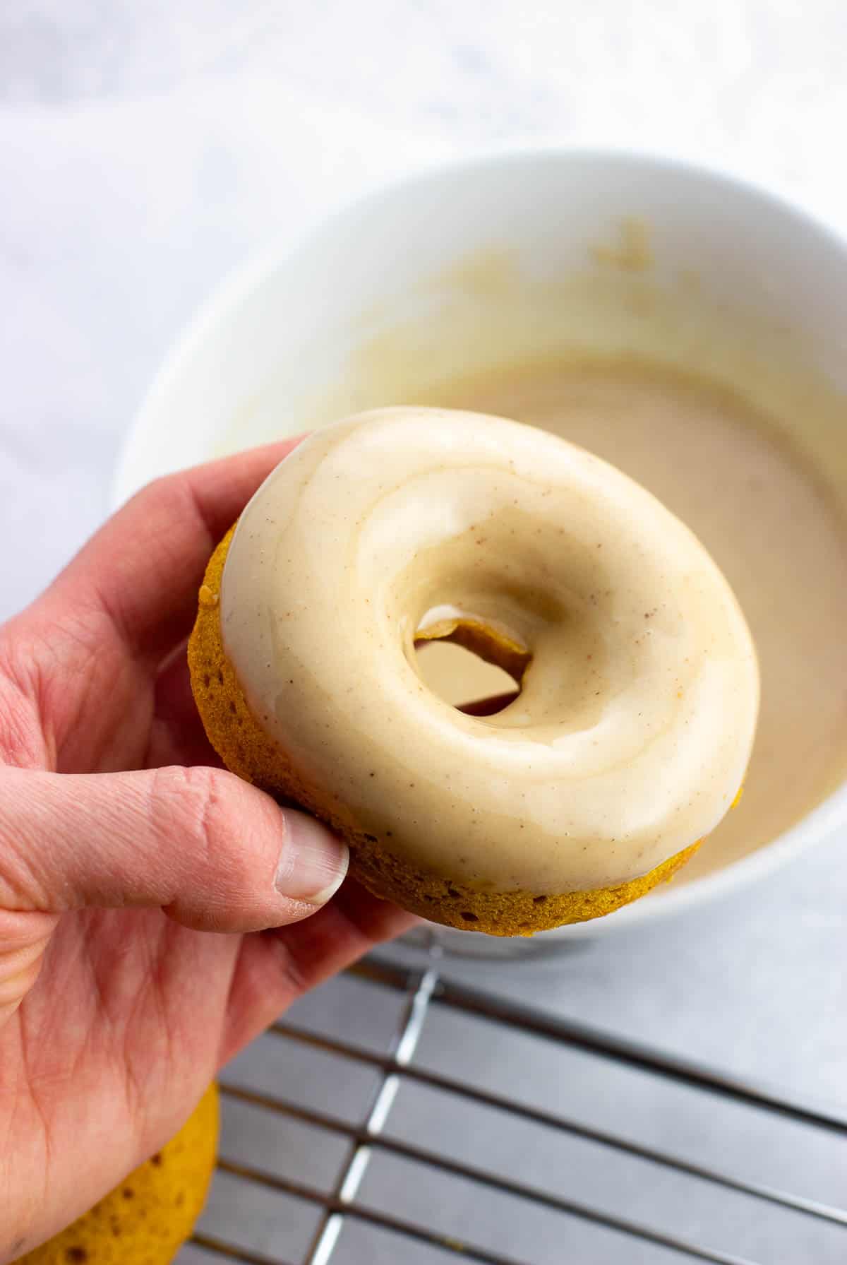 A freshly-glazed pumpkin donut.