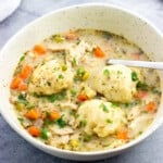 A shallow bowl of chicken and Bisquick dumplings.